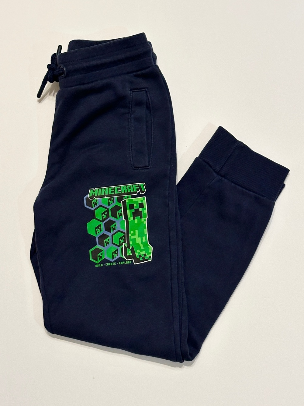 Minecraft blue sweatpants with green creeper graphic for boys in Size 7-8.